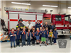 Group of Scouts Stand with Belmont Firefighters in Front of Engine 3
