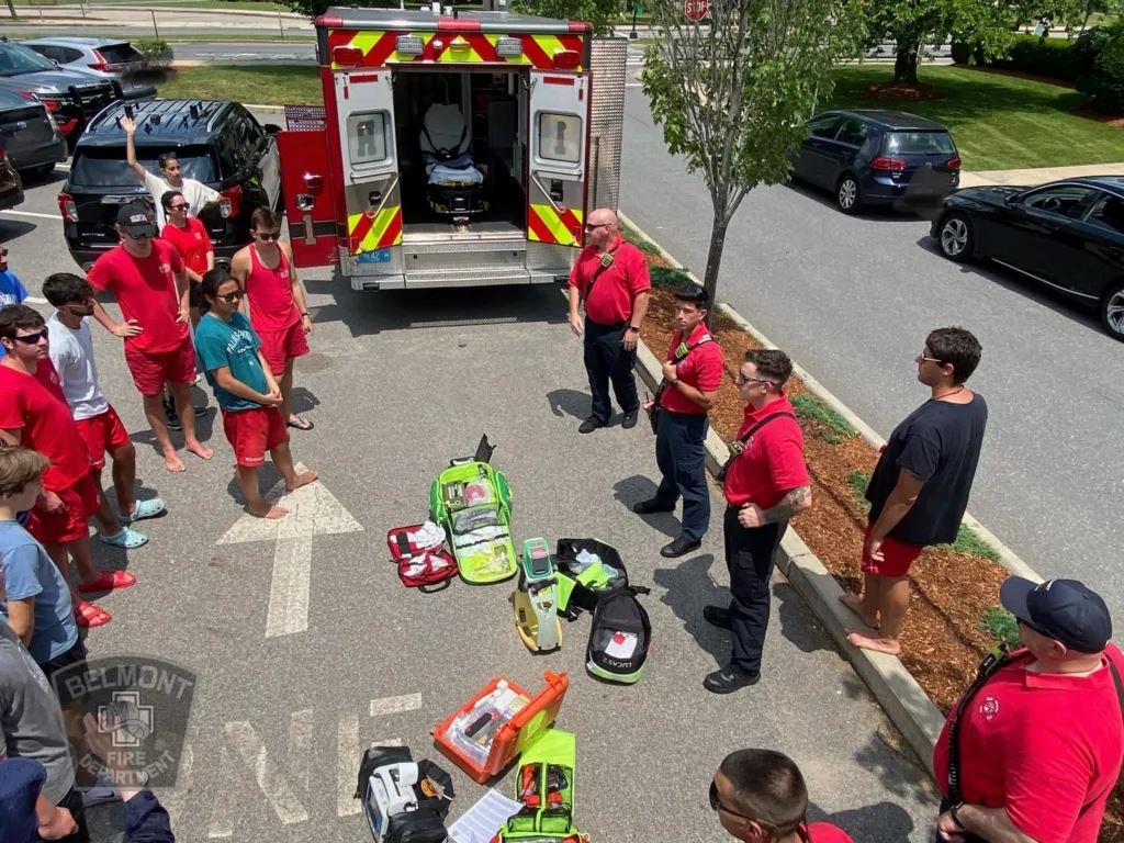 Crowd Standing Around Fire Department Members and Rescue Truck